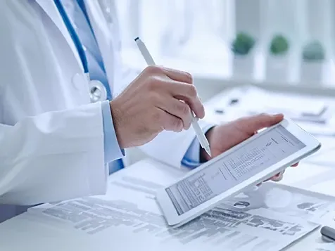 health professional scribbling on a notepad