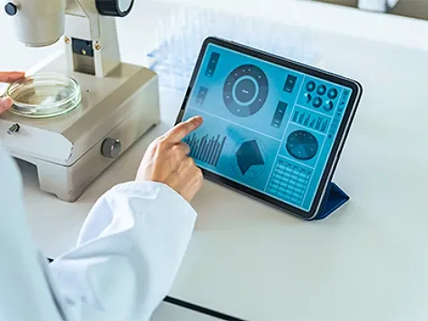 A lab technician browsing data on a tablet