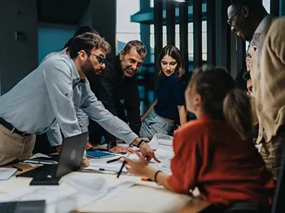 A group of people around a desk, brainstorming