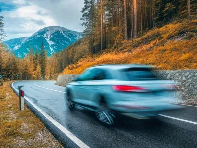 View of a silver car driving by.