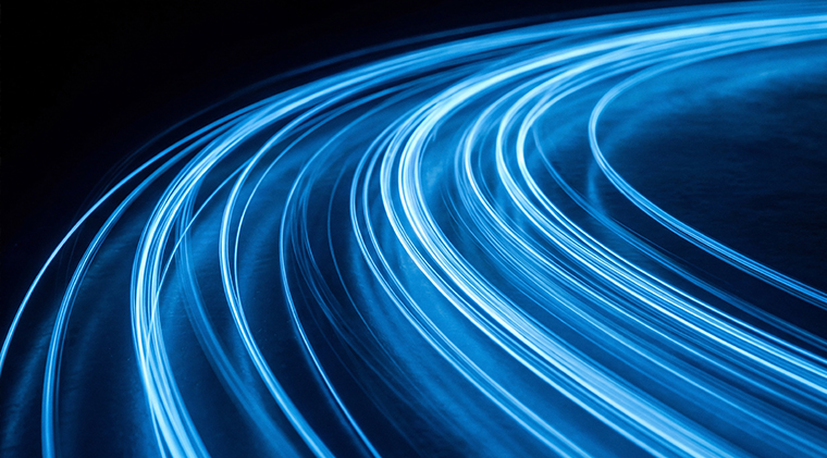 Abstract glowing data wave over illuminated digital landscape.