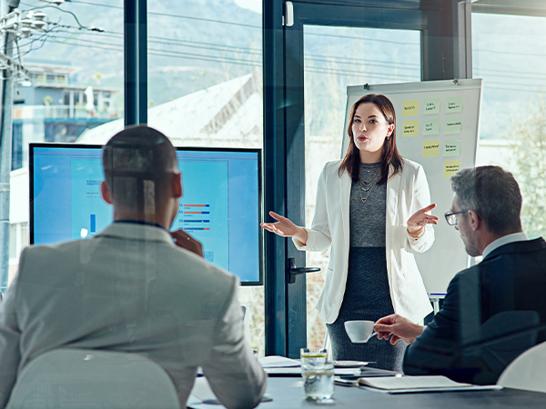 three people collaborate and discuss in meeting room
