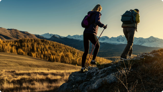 pair of hikers walking trail