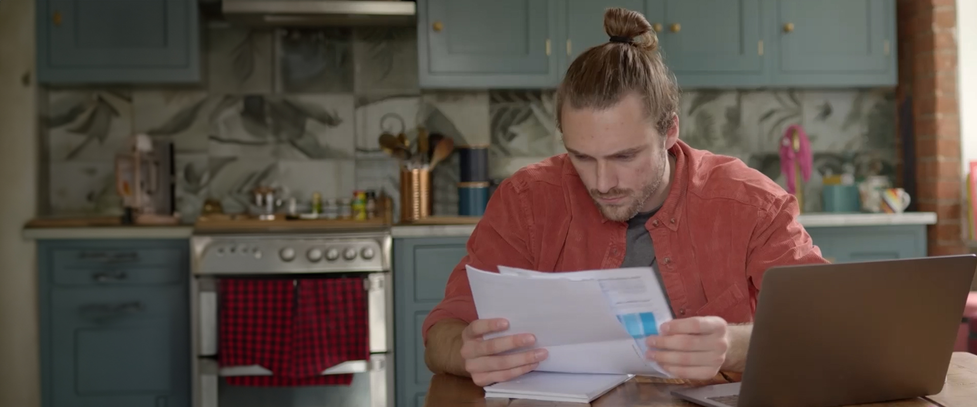 A person looking at papers sitting at a table