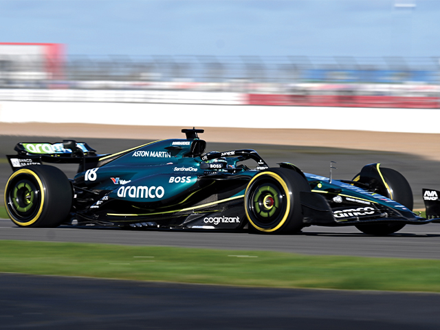A vibrant green racing car navigates a track, emphasizing its speed and competitive spirit.