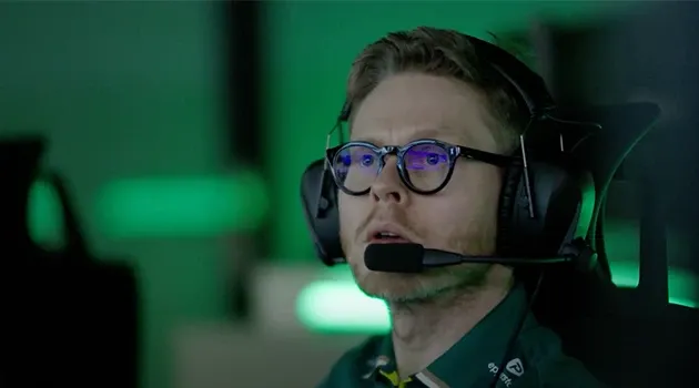 A male wearing headset looking at screen.