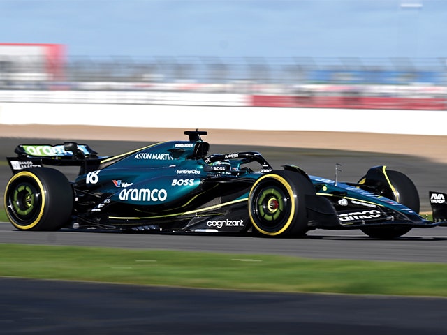 A vibrant green racing car navigates a track, emphasizing its speed and competitive spirit.