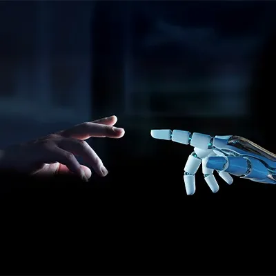 A robotic hand extends towards a human hand, symbolizing connection between technology and humanity.
