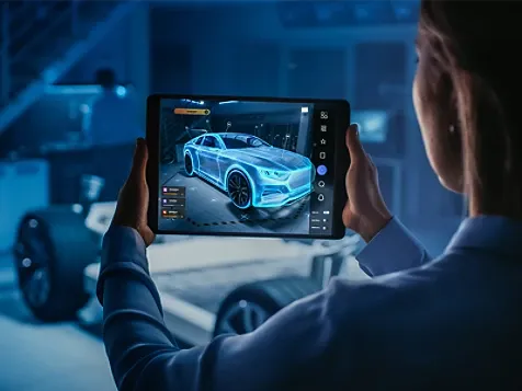 A person viewing a futuristic car on tablet.