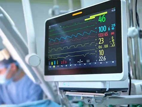 A computer monitor displaying an electronic heart monitor with fluctuating heart rate readings.