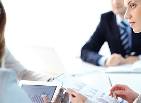 Partial view of a woman face looking at her colleague during a meeting.