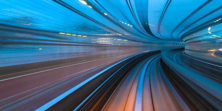 Vehicles speeding on a highway shown as a series of curved lines