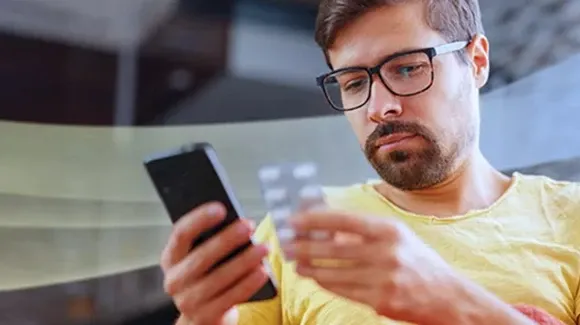 woman wearing a mask looking at phone