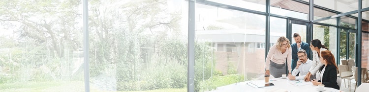 A woman wearing a headset is looking at a screen, appearing concentrated on her digital interaction.