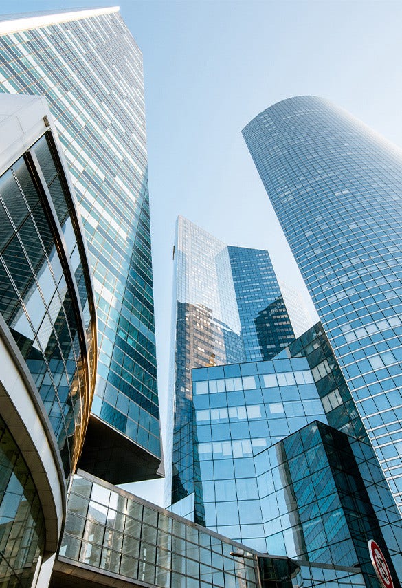 Contemporary glass-and-steel skyscrapers and office towers in a financial district, symbolizing banking, finance, and corporate business.