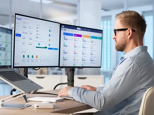 Person working on dual monitor