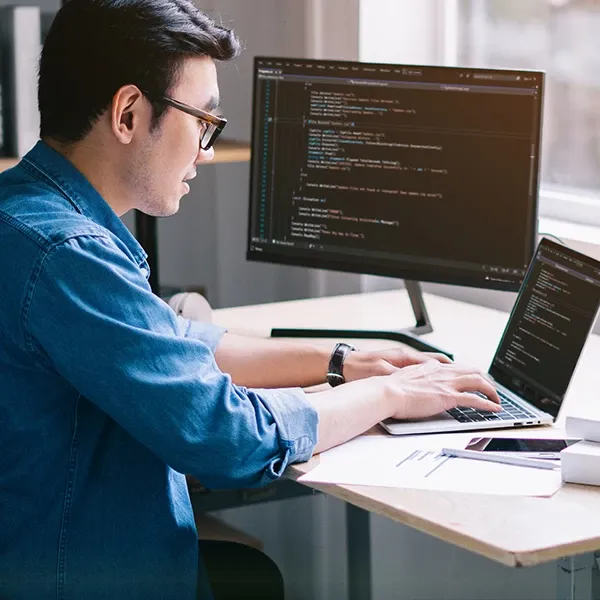 A man engaged in coding and software testing.