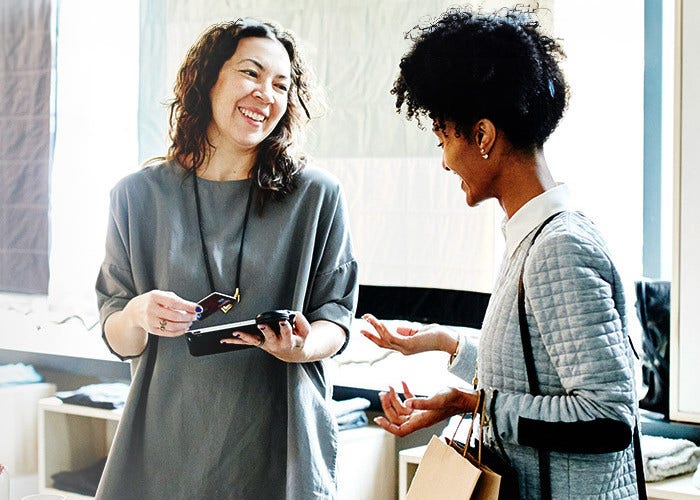 Two women engaged in a discussion at the office.