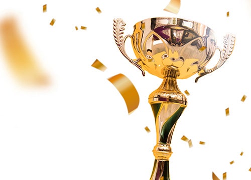 A golden trophy surrounded by colorful confetti falling from above, celebrating a significant achievement.