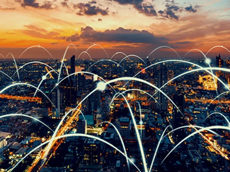 Aerial view of a city skyline with network connection lines.