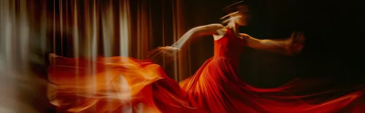 alt text within 10 words 1:16 PM Dancer in red dress spinning with motion blur