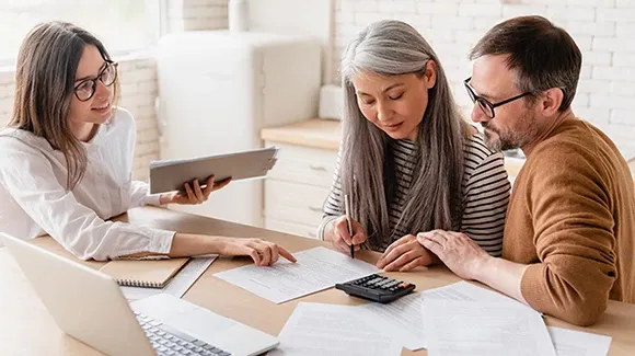 Three persons were discussing with some documents